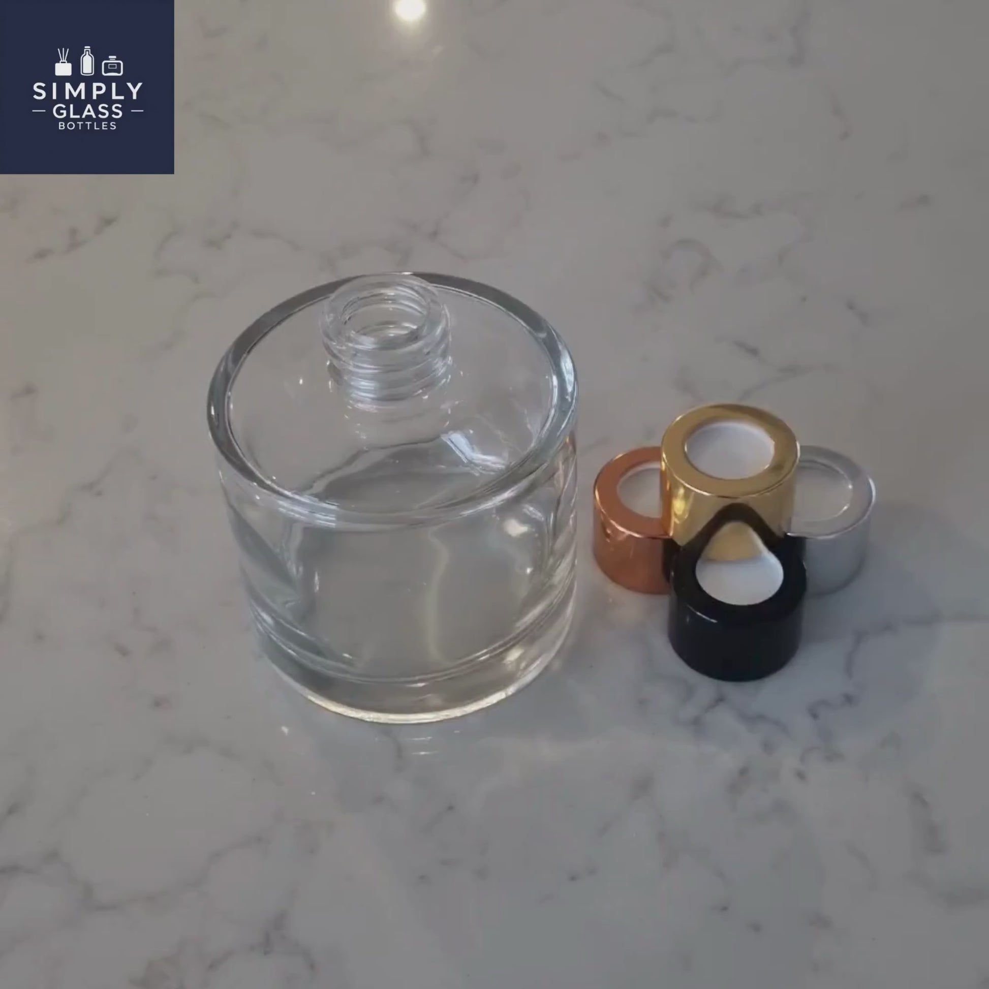 Gold diffuser caps next to clear glass diffuser bottle